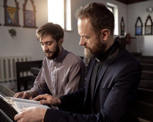 close-up-priest-talking-with-person